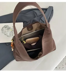 Interior view of large brown hobo bag showing spacious storage for laptop and daily items