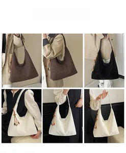 Detail view of large tote bags in brown and black with chic beaded tassel charms