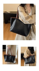 Detail of hand-woven patchwork tote bag with black body and brown contrast leather straps