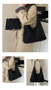 Detail of minimalist black matte tote bag set featuring wooden bead charm and small pouch