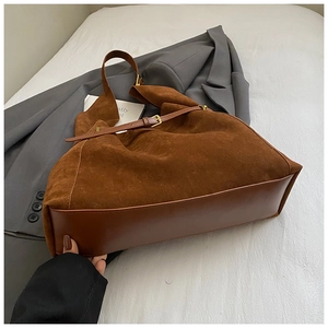 Détail du grand sac cabas vintage en daim marron avec boucles en métal couleur bronze