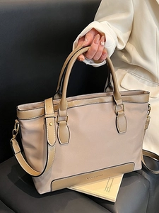 Large capacity beige tote bag with brown leather trim and adjustable wide strap