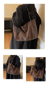 Close-up of brown suede tote bag with metal buckle and decorative woven knot detail