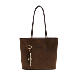 Brown faux suede tote bag with plush charm and minimalist shoulder straps
