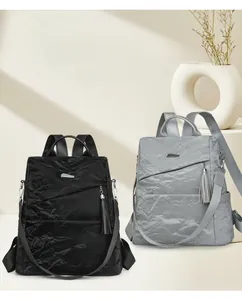 Detail of soft leather travel backpack showing the detachable strap and anti-theft design