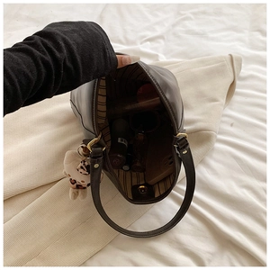 Spacious interior of dark brown tote bag showing storage for umbrella and phone