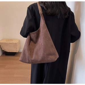Brown matte suede tote bag with large capacity shown on model for a minimalist style