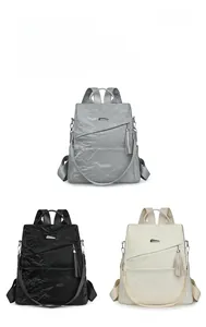 Detailed comparison of gray, black, and beige soft leather backpacks with metal accents
