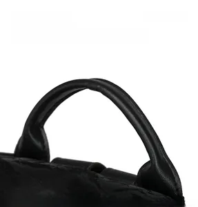 Close-up of the reinforced black leather handle with smooth texture and ergonomic grip