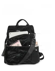 Detail view of large capacity black soft leather backpack showing storage compartments