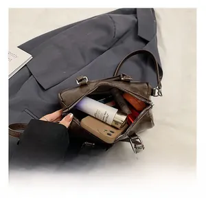 Interior view of the brown Boston bag showing capacity for phone and cosmetics