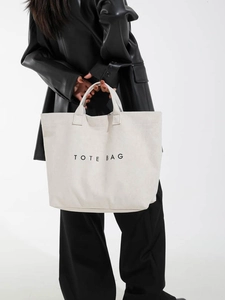 Minimalist large capacity off-white canvas tote bag for women with black lettering
