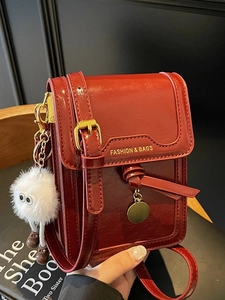Retro deep red glossy leather crossbody bag with cute plush pendant and gold charm