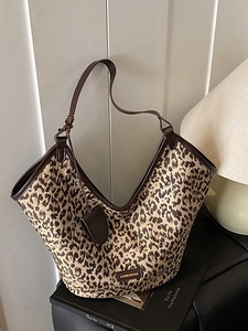 Large leopard print canvas tote bag with brown leather trim for fashion-forward commuting