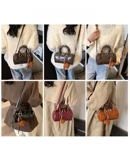 Detailed views of vintage Boston bags in multiple colors with bear pendant charm