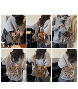 Detail view of leopard print tote bags with leather flap and plush bear charm