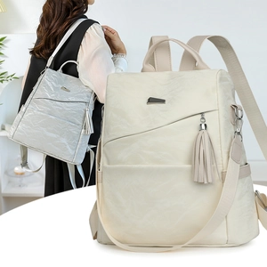 Chic soft faux leather backpack for women with tassel charm in beige and light grey tones