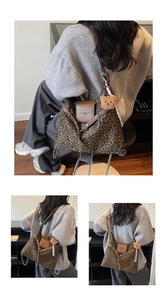 Close-up of leopard print shoulder bag with brown leather accents and a plush bear charm