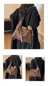 Detail of leopard print tote bag with leather flap, metal chain, and cute bear charm