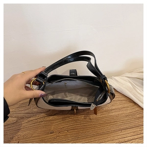 Detailed top view of crescent bag interior with grey lining and gold-tone hardware