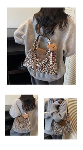 Detail of leopard print tote bag with brown leather flap and cute plush bear charm