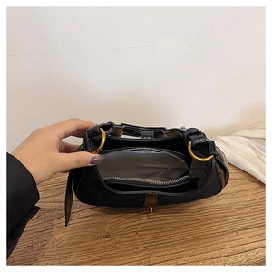 Interior view of black crescent bag with golden hardware and zipped compartment