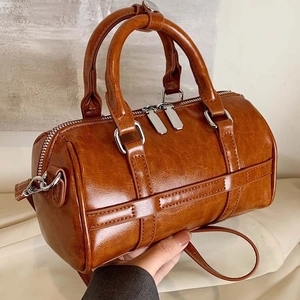 Brown vintage Boston handbag with glossy crackled texture and silver polished hardware