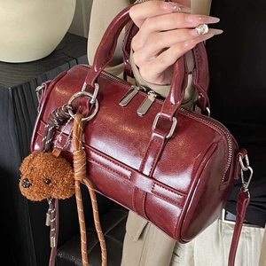 Retro reddish brown Boston bag in oil wax leather finish with plush bear charm