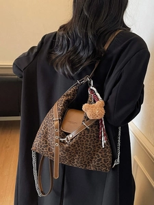 Stylish leopard print tote bag with brown leather trim and silver chain shoulder strap