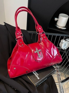 Red patent leather motorcycle bag with silver metallic cross and stud accents