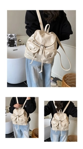 Vue détaillée du sac à dos en cuir blanc crème avec grand compartiment et rabat