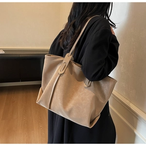 Chic large capacity khaki tote bag with vintage texture shown on a female model