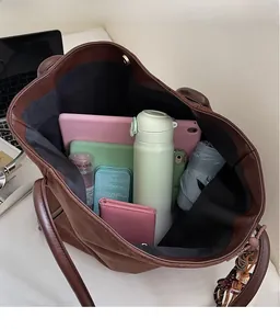Brown suede tote bag interior showing large capacity for iPad, umbrella and bottle