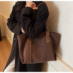 Deep brown oversized retro tote bag featuring vertical stitching and minimalist matte finish