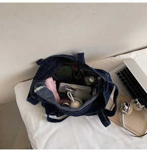Top view of spacious deep blue denim tote bag interior showing multi-compartment storage