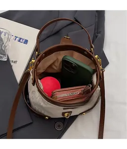Top view of bucket bag showing spacious interior with canvas print and leather trim