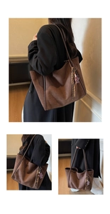 Detail of dark brown faux suede tote bag with woven tassel and sequin bear charm