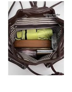 Deep brown PU backpack with striped lining showing daily storage capacity and inner zip pocket