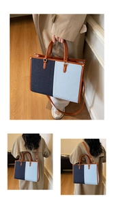 Detail of color-block denim tote bag with brown leather trim and adjustable shoulder strap
