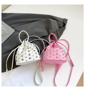 Detail of pink and white bucket bags featuring silver studs and drawstring closure