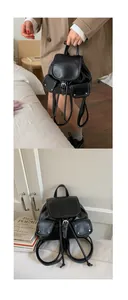 Detail of vintage black leather backpack with contrast stitching and dual front pockets