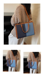 Detail of blue denim patchwork tote bag with brown leather trim and shoulder strap