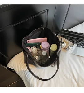 Spacious interior of a dark brown leather tote bag showing large capacity for essentials