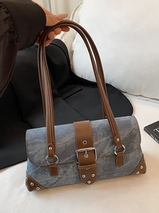 Retro denim shoulder bag with leather straps and silver rivet accents in a stylish design
