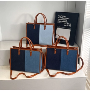 Three-color patchwork denim tote bags with leather straps on a modern white display