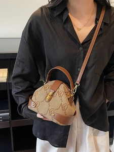 Vintage brown monogram handbag with leather trim and adjustable crossbody strap