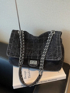 Chic black denim quilted shoulder bag with chain strap and silver twist lock