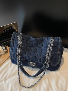 Deep blue denim chain tote bag with classic quilted stitching and silver metal buckle