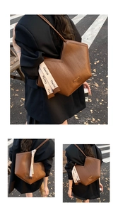 Detail of brown chevron embossed tote bag featuring a V-cut top and branded silk ribbon