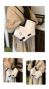 Detail view of canvas tote bag showing the unique V-shaped opening and black shoulder strap